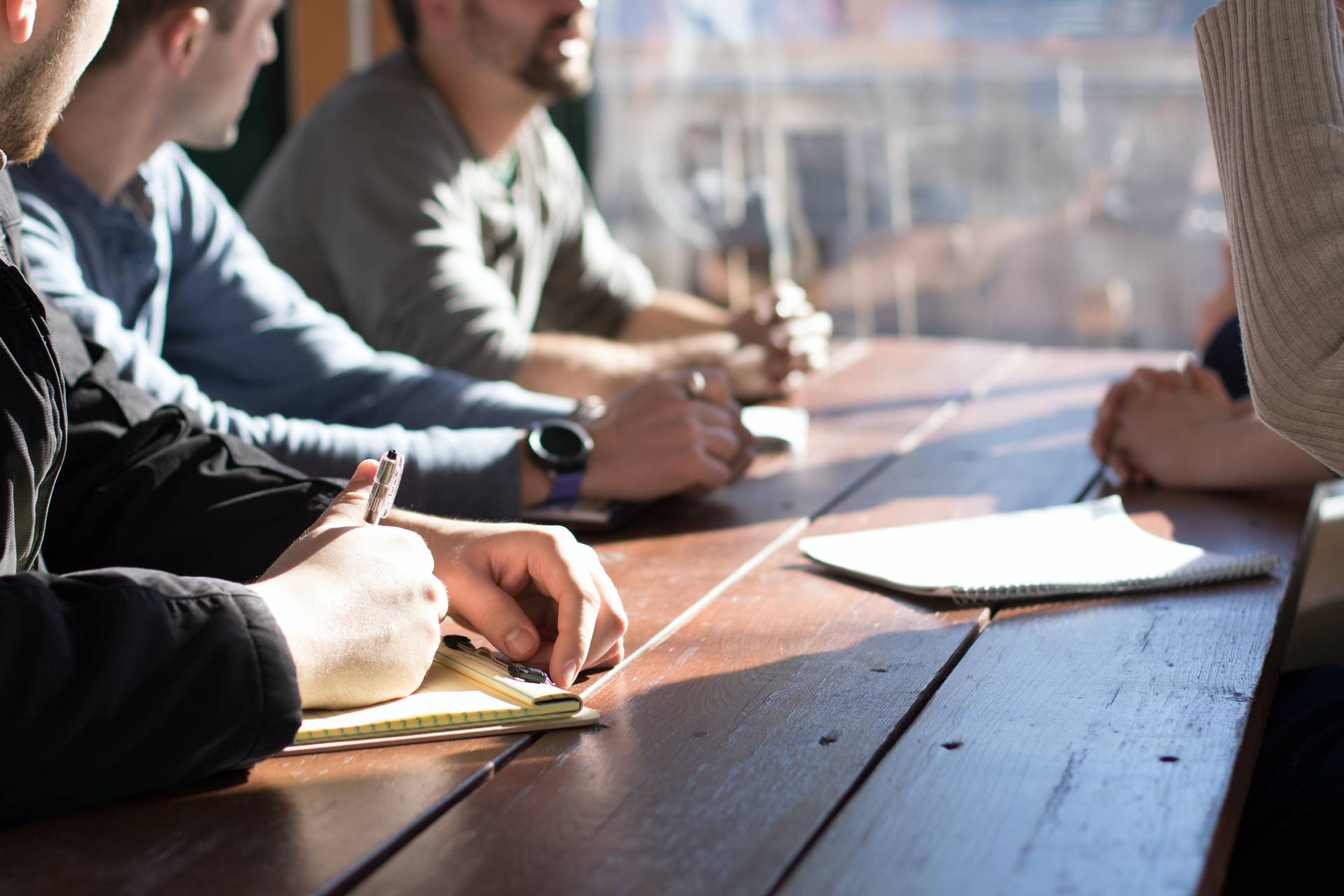 Photo shows people sitting at a table